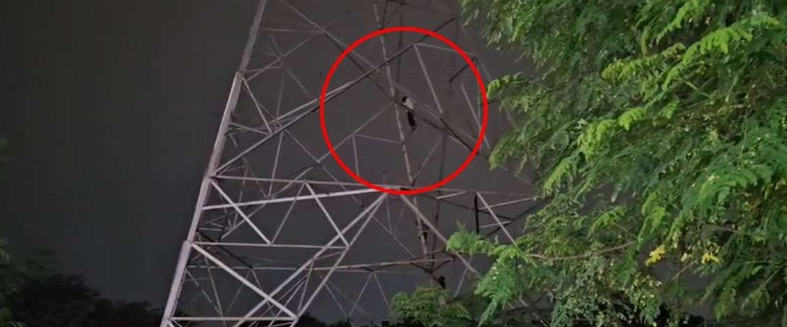 Youth climbs high tension tower
